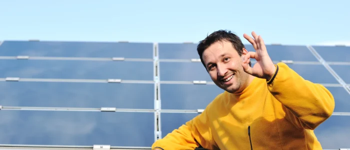 young-male-engineer-with-solar-panels-background